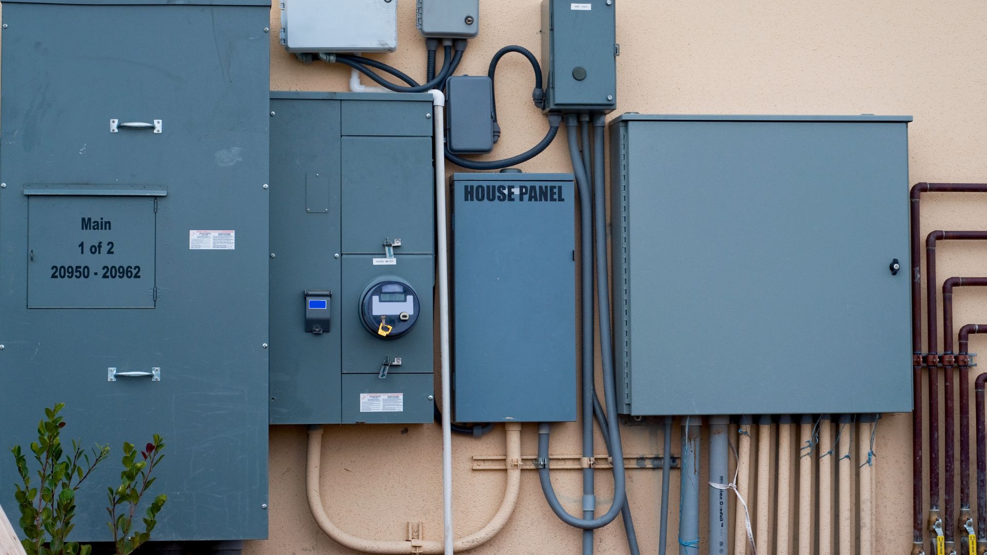 A wall with some electrical equipment attached to it