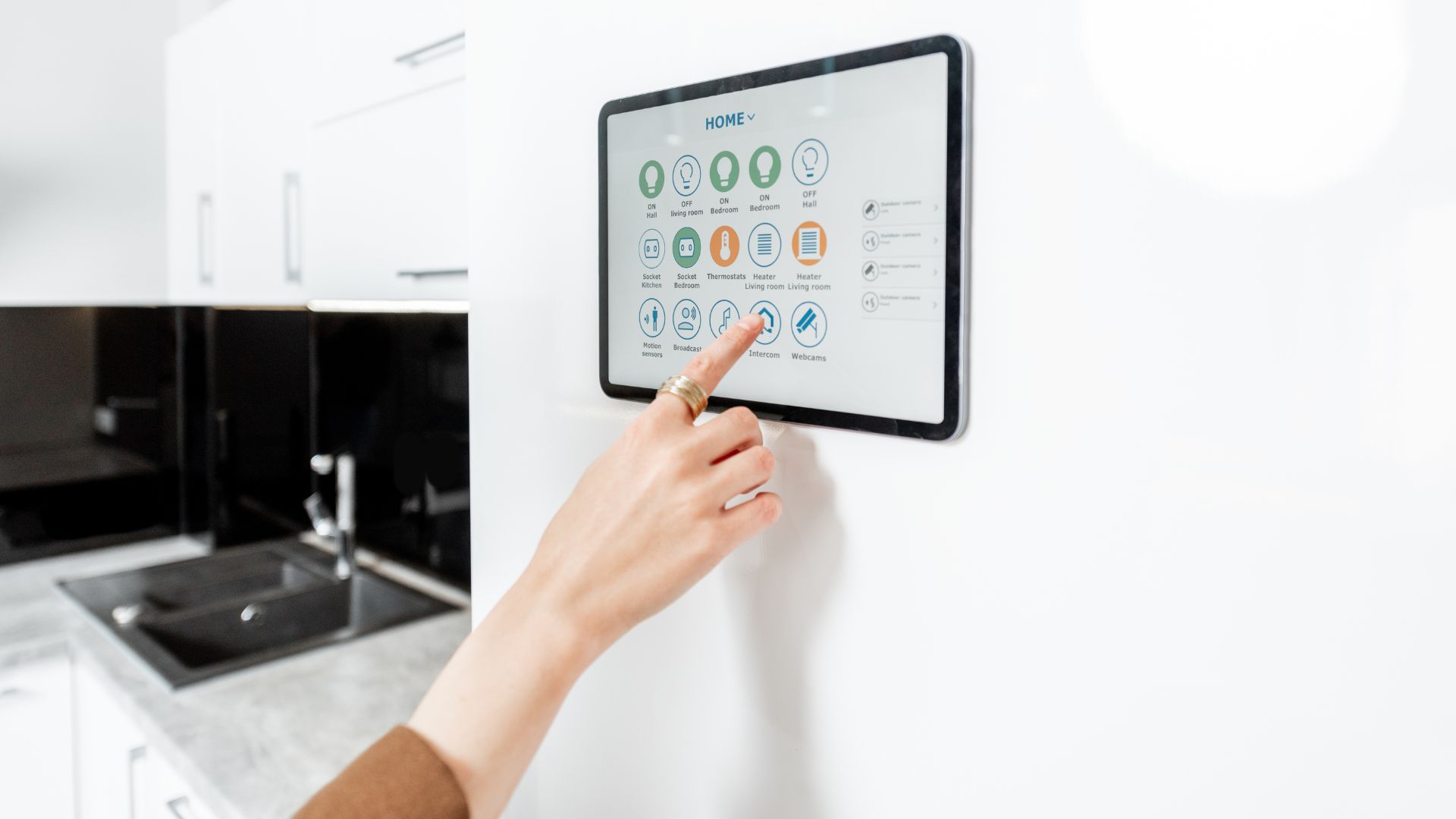 A person pressing buttons on a wall mounted appliance